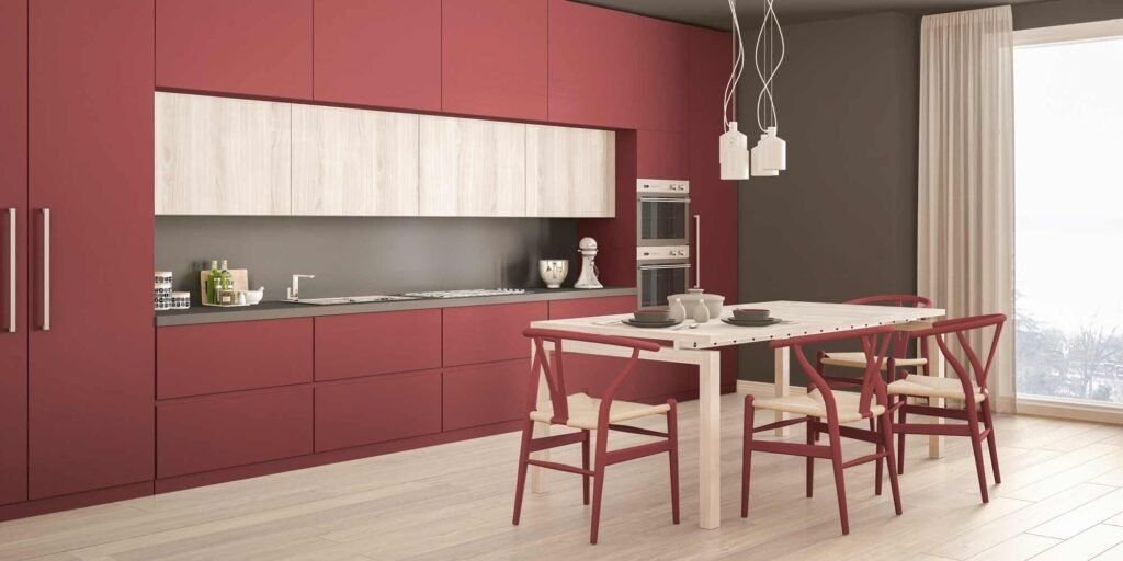 A-kitchen-with-shiny-red-cabinets-and-an-industrial-style-backsplash-under-soft-pendant-lighting
